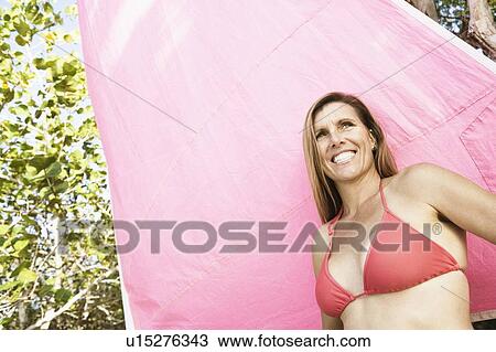 Low angle view of a mid adult woman smiling View Large Photo Image Stock Image - Low angle view of a mid adult woman smiling. Fotosearch