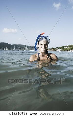 Portrait of a mid adult woman standing in water and smiling View Large Photo Image Stock Photo - Portrait of a mid adult woman standing in water and smiling. Fotosearch