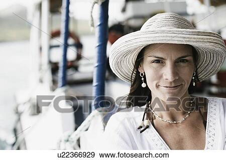 Portrait of a mid adult woman wearing a sunhat View Large Photo Image Stock Photo - Portrait of a mid adult woman wearing a sunhat. Fotosearch