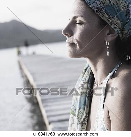 Side profile of a mid adult woman with her eyes closed View Large Photo Image Stock Image - Side profile of a mid adult woman with her eyes closed. Fotosearch