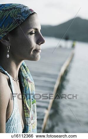 Stock Photograph - Side profile of a mid adult woman with her eyes closed. Fotosearch