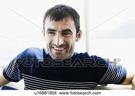 Close-up of a mid adult man smiling View Large Photo Image Picture - Close-up of a mid adult man smiling. Fotosearch