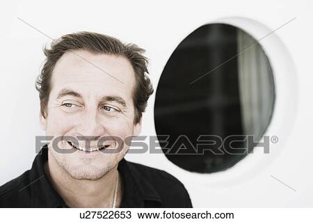 Close-up of a mid adult man smiling View Large Photo Image Stock Image - Close-up of a mid adult man smiling. Fotosearch