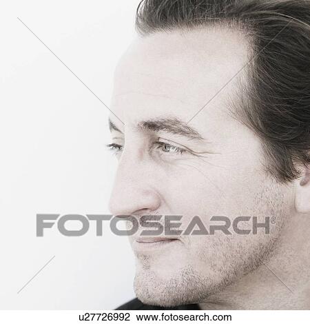 Close-up of a mid adult man smiling View Large Photo Image Stock Image - Close-up of a mid adult man smiling. Fotosearch