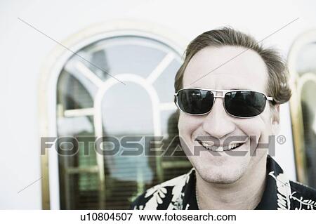 Stock Photo - Close-up of a mid adult man smiling. Fotosearch