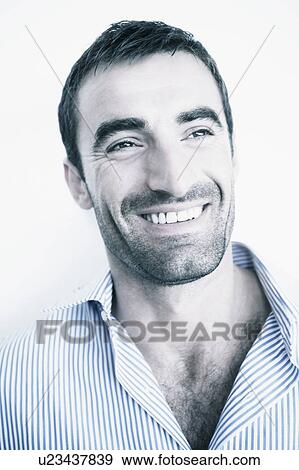 Stock Photo - Close-up of a mid adult man smiling. Fotosearch
