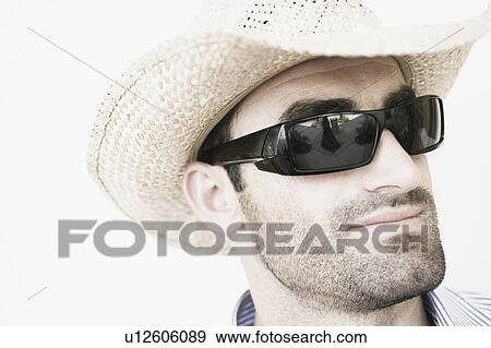 Close-up of a young man wearing sunglasses View Large Photo Image Stock Photo - Close-up of a young man wearing sunglasses. Fotosearch
