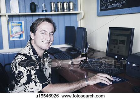 Portrait of a mid adult man using a computer View Large Photo Image Stock Photograph - Portrait of a mid adult man using a computer. Fotosearch