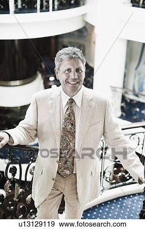 Portrait of a senior man moving up on a staircase in a ship View Large Photo Image Stock Photo - Portrait of a senior man moving up on a staircase in a ship. Fotosearch