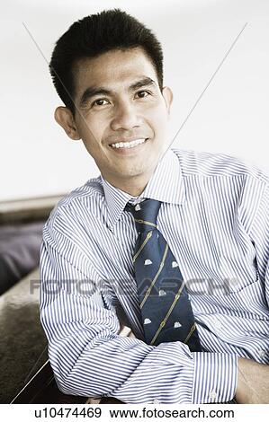 Portrait of a young man smiling View Large Photo Image Stock Photo - Portrait of a young man smiling. Fotosearch