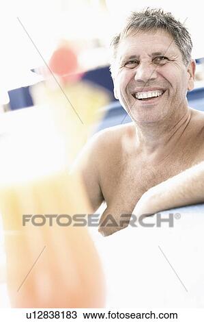Senior man smiling in a swimming pool View Large Photo Image Stock Image - Senior man smiling in a swimming pool. Fotosearch