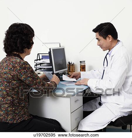 Close-up of a male doctor with a patient in his office View Large Photo Image Stock Photography - Close-up of a male doctor with a patient in his office. Fotosearch