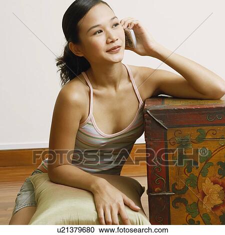 Young woman talking on a mobile phone View Large Photo Image Stock Image - Young woman talking on a mobile phone. Fotosearch