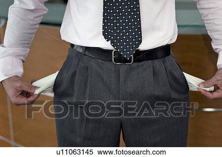 Businessman pulling out empty pockets View Large Photo Image Stock Photography - Businessman pulling out empty pockets. Fotosearch