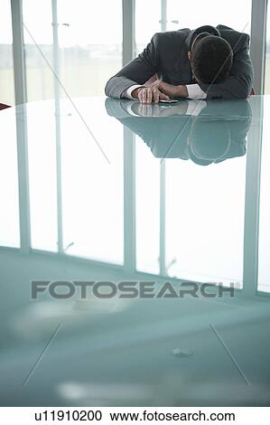 Businessman resting his head on desk View Large Photo Image Stock Image - Businessman resting his head on desk. Fotosearch