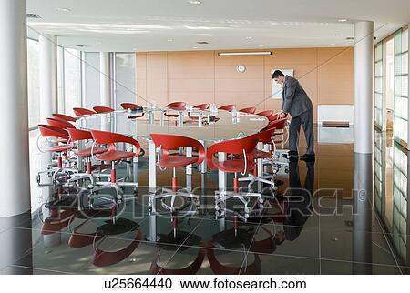 Stock Image - Businessman waiting in conference room. Fotosearch