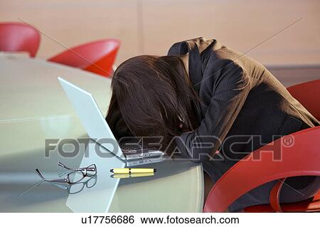 Businesswoman with head down on conference table View Large Photo Image Stock Photograph - Businesswoman with head down on conference table. Fotosearch
