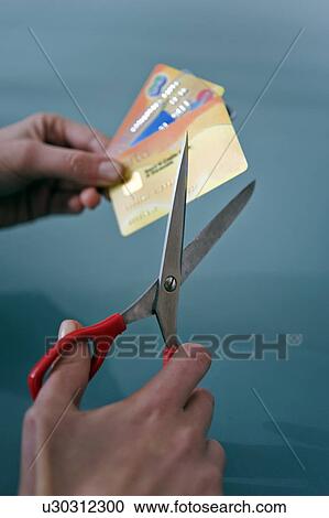 Hands cutting credit cards with scissors View Large Photo Image Stock Image - Hands cutting credit cards with scissors. Fotosearch
