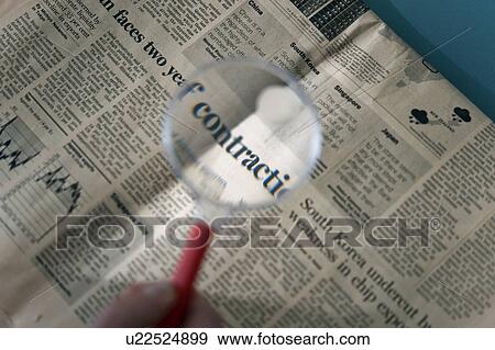 Magnifying glass over financial section of newspaper View Large Photo Image Stock Photo - Magnifying glass over financial section of newspaper. Fotosearch