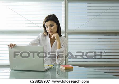 Stock Photo - Professional woman looking at laptop. Fotosearch