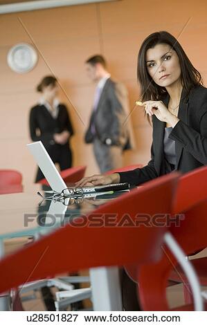 Stock Photo - Businesswoman at meeting with laptop. Fotosearch