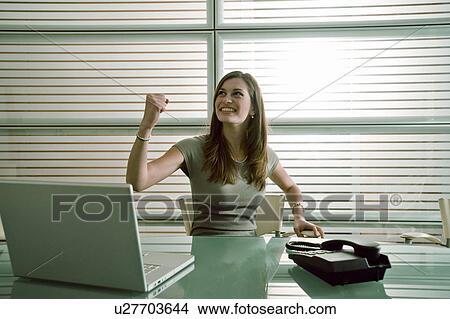 Happy businesswoman at desk View Large Photo Image Picture - Happy businesswoman at desk. Fotosearch