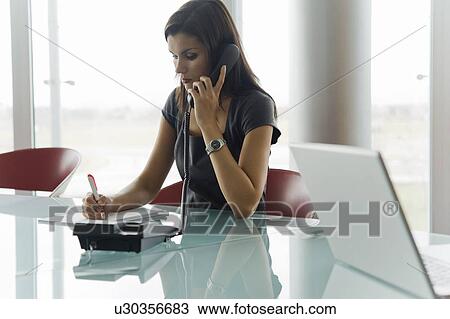 Stock Image - Professional woman on telephone. Fotosearch