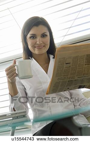 Professional woman with newspaper and coffee cup View Large Photo Image Stock Image - Professional woman with newspaper and coffee cup. Fotosearch