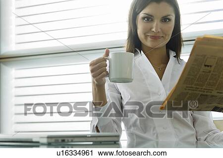 Professional woman with newspaper and coffee cup View Large Photo Image Stock Image - Professional woman with newspaper and coffee cup. Fotosearch