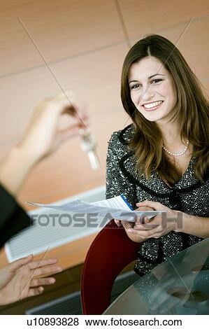 "Young woman holding document, female hand holding keys" View Large Photo Image Stock Photo - "Young woman holding document, female hand holding keys". Fotosearch