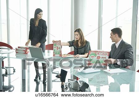 Business people with pizza boxes at desk View Large Photo Image Picture - Business people with pizza boxes at desk. Fotosearch