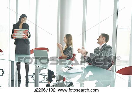 Businesswoman bringing pizza to business people at desk View Large Photo Image Stock Image - Businesswoman bringing pizza to business people at desk. Fotosearch
