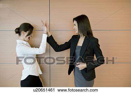 Businesswomen doing high five View Large Photo Image Stock Image - Businesswomen doing high five. Fotosearch