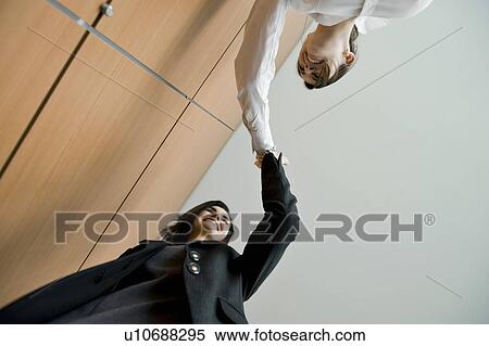 Businesswomen doing high five View Large Photo Image Stock Photography - Businesswomen doing high five. Fotosearch