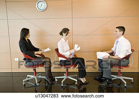 Office workers sitting in chairs with documents View Large Photo Image Stock Image - Office workers sitting in chairs with documents. Fotosearch