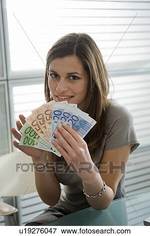 Stock Photo - Professional woman holding euro bills. Fotosearch