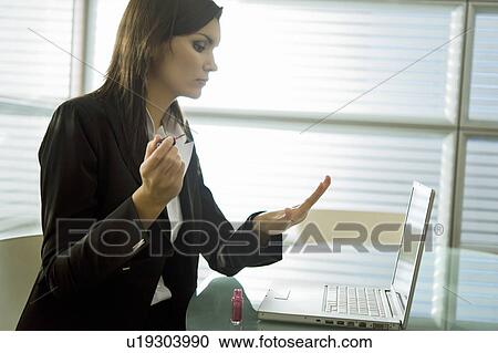 Professional woman with nail polish at desk with laptop View Large Photo Image Stock Image - Professional woman with nail polish at desk with laptop. Fotosearch