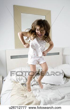 Girl jumping on bed View Large Photo Image Stock Photo - Girl jumping on bed. Fotosearch