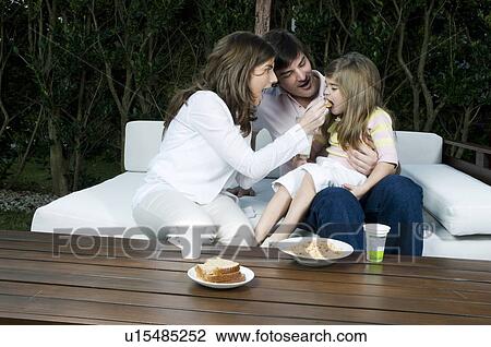 Young couple and girl having breakfast outdoors View Large Photo Image Stock Image - Young couple and girl having breakfast outdoors. Fotosearch