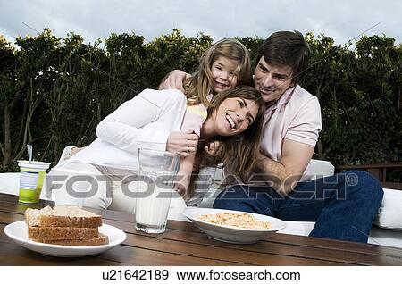 Young couple and girl having breakfast outdoors View Large Photo Image Stock Photo - Young couple and girl having breakfast outdoors. Fotosearch