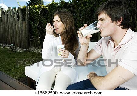 Young couple having breakfast outdoors View Large Photo Image Stock Image - Young couple having breakfast outdoors. Fotosearch