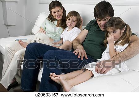 Young couple on couch with children and dog View Large Photo Image Stock Photo - Young couple on couch with children and dog. Fotosearch