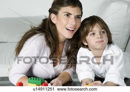 Young woman and boy playing with building blocks View Large Photo Image Stock Image - Young woman and boy playing with building blocks. Fotosearch
