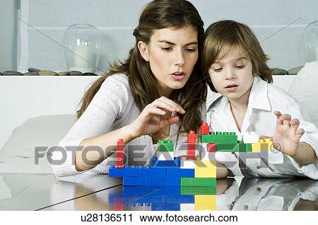 Young woman and boy playing with building blocks View Large Photo Image Stock Image - Young woman and boy playing with building blocks. Fotosearch