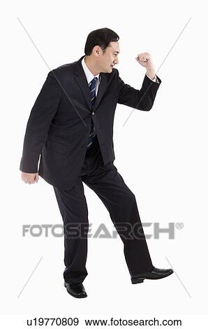 Businessman bending with one fist up, Business People View Large Photo Image Stock Photo - Businessman bending with one fist up, Business People. Fotosearch