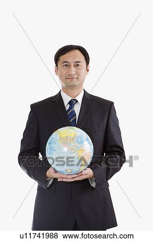 Businessman holding a globe and looking at the camera, Business People View Large Photo Image Stock Photo - Businessman holding a globe and looking at the camera, Business People. Fotosearch