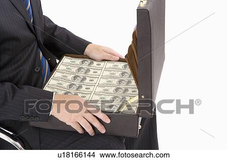 Picture - Businessman holding a suitcase of paper money, Business People. Fotosearch