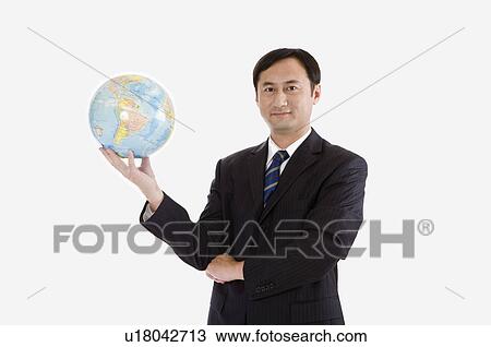 Businessman holding globe with one hand and looking at the camera, Business People View Large Photo Image Stock Image - Businessman holding globe with one hand and looking at the camera, Business People. Fotosearch