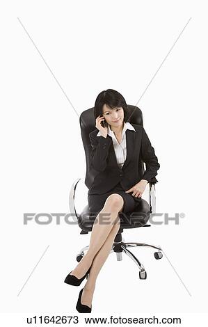 Businesswoman sitting on chair and on the phone, Business People View Large Photo Image Stock Image - Businesswoman sitting on chair and on the phone, Business People. Fotosearch