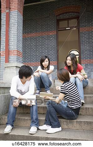 Four people sitting on stairs and discussing, Studying, Education View Large Photo Image Stock Photography - Four people sitting on stairs and discussing, Studying, Education. Fotosearch